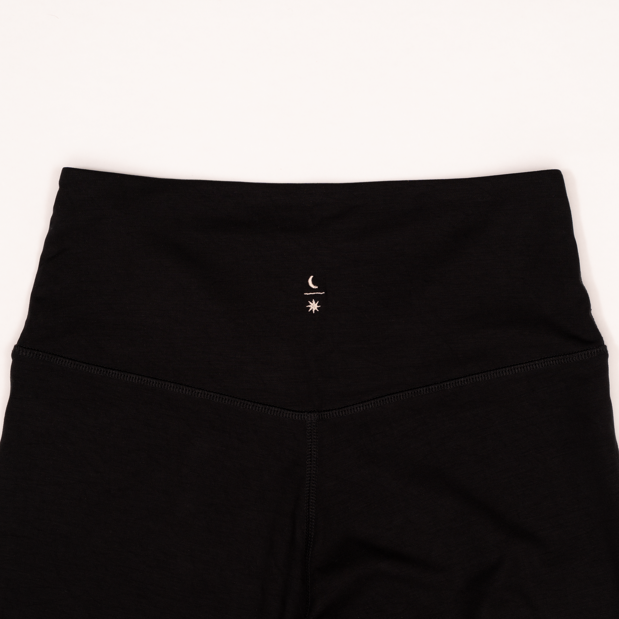 Ainé leggings back view showing embroidered logo detail